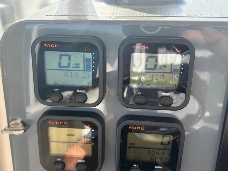 Slide: The Image of Dashboard of a 2014 Pursuit C 260 Center Console boat showing tachometer, speed, and fuel gauges. - 15