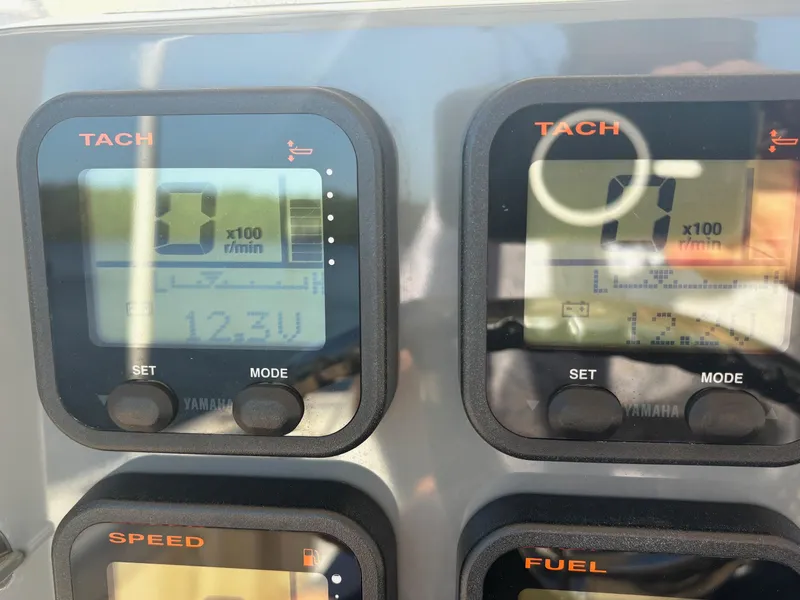 Slide: The Image of Close-up of Yamaha tachometer displays on a 2014 Pursuit C 260 Center Console boat. - 16
