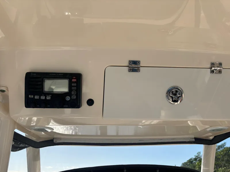 Slide: The Image of 2014 Pursuit C 260 Center Console dashboard with control panel and storage compartment. - 18