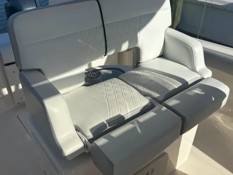 Slide: The Image of 2014 Pursuit C 260 Center Console boat seat with light gray upholstery. - 19