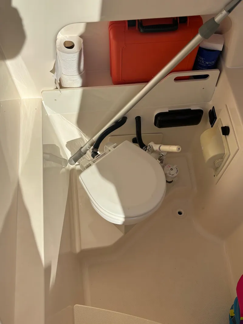 Slide: The Image of 2014 Pursuit C 260 Center Console boat toilet with storage and accessories. - 21