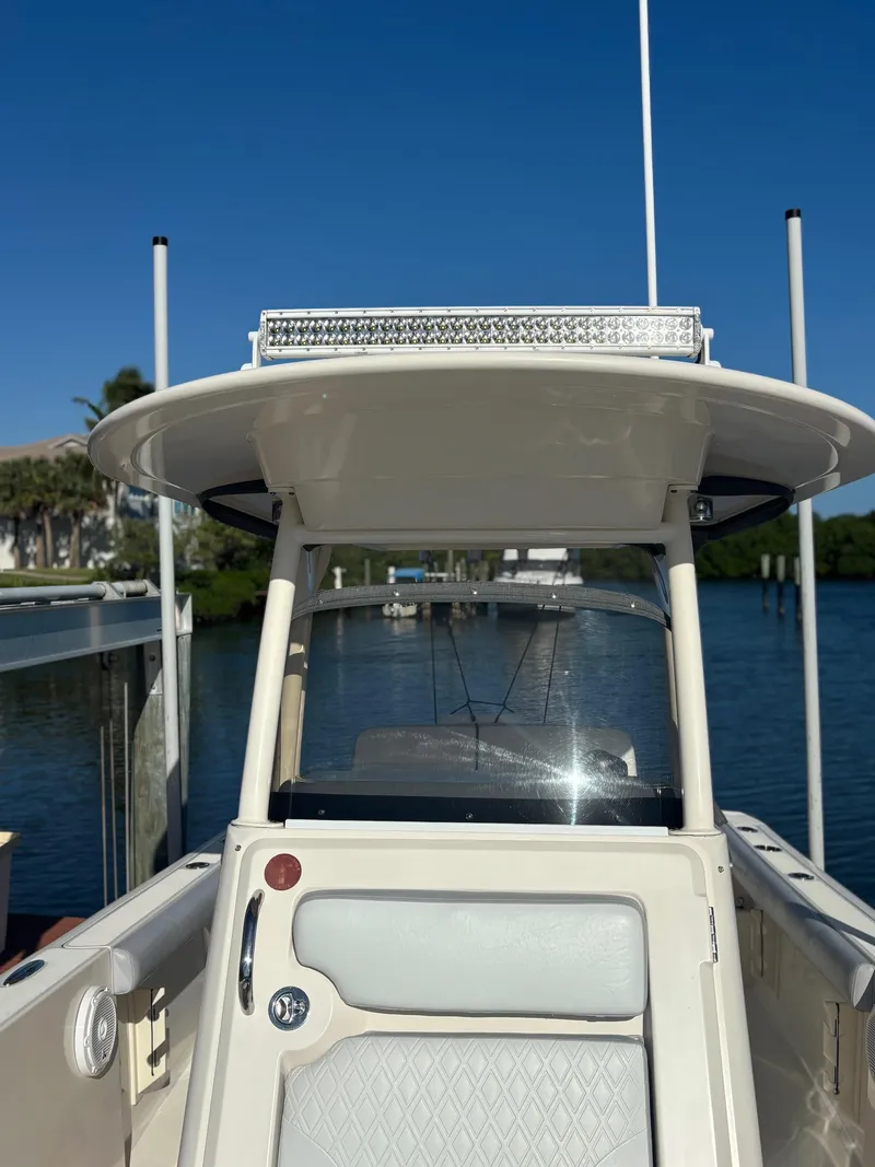 Slide: The Image of 2014 Pursuit C 260 Center Console boat docked by the water. - 7