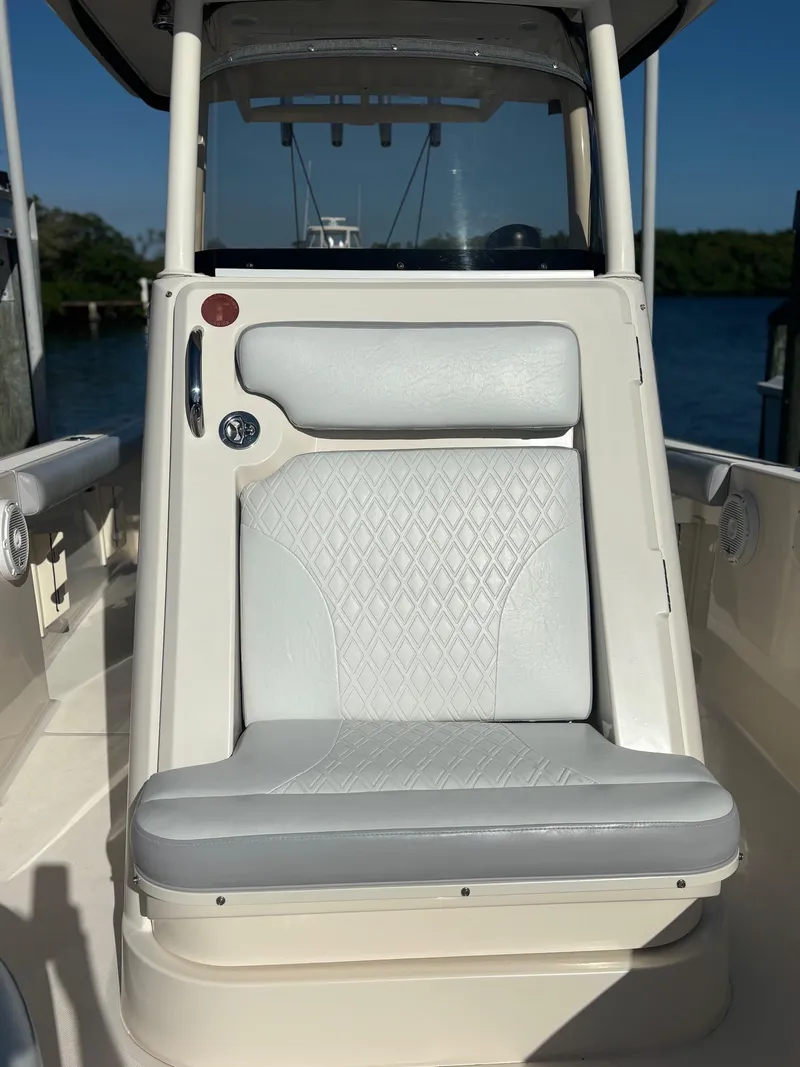 Slide: The Image of 2014 Pursuit C 260 Center Console boat seat with cushioned backrest. - 8