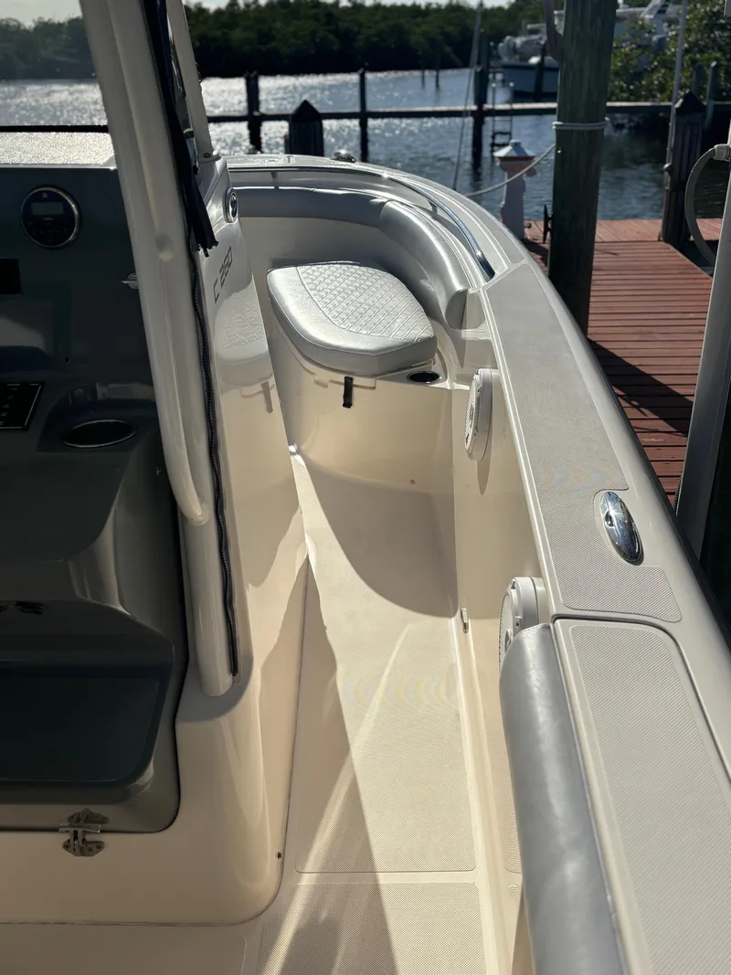 Slide: The Image of 2014 Pursuit C 260 Center Console boat docked by the water. - 9