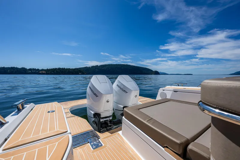 Slide: The Image of Luxury Nimbus W11 boat with twin Mercury engines on a serene lake, 2025 model. - 11