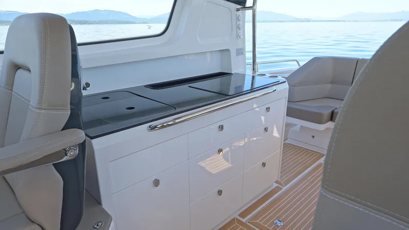 Slide: The Image of Interior of 2025 Nimbus W11 boat with sleek kitchen and seating area. - 16