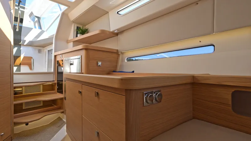 Slide: The Image of Luxurious interior of 2025 Nimbus W11 yacht with modern wood finishes and natural light. - 21