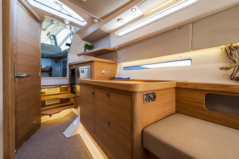 Slide: The Image of Luxurious interior of 2025 Nimbus W11 yacht with wooden cabinetry and modern lighting. - 24