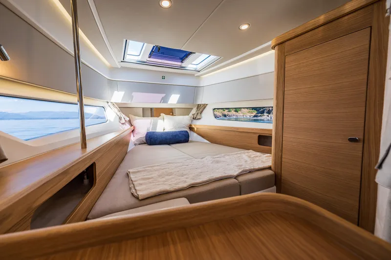 Slide: The Image of Luxurious interior cabin of 2025 Nimbus W11 yacht with cozy bed and scenic windows. - 25
