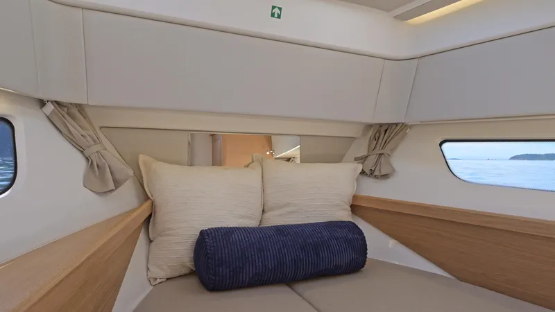 Slide: The Image of Cozy interior cabin of 2025 Nimbus W11 yacht with pillows and sea view. - 26