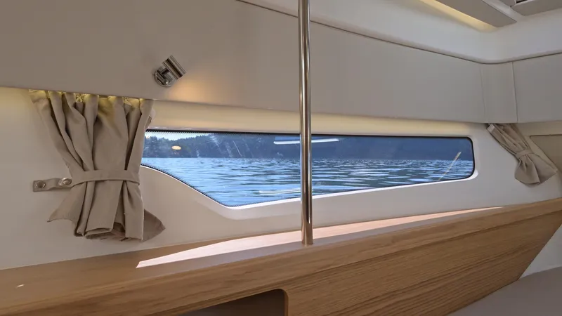 Slide: The Image of Interior view of 2025 Nimbus W11 boat with window overlooking water. - 27