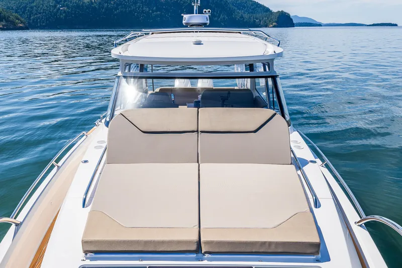 Slide: The Image of Luxurious 2025 Nimbus W11 yacht with sunbathing deck on serene water. - 32