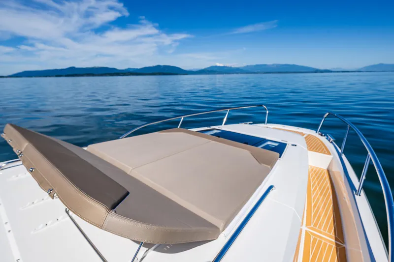 Slide: The Image of Luxurious Nimbus W11 2025 boat with sunbed on calm blue waters. - 33