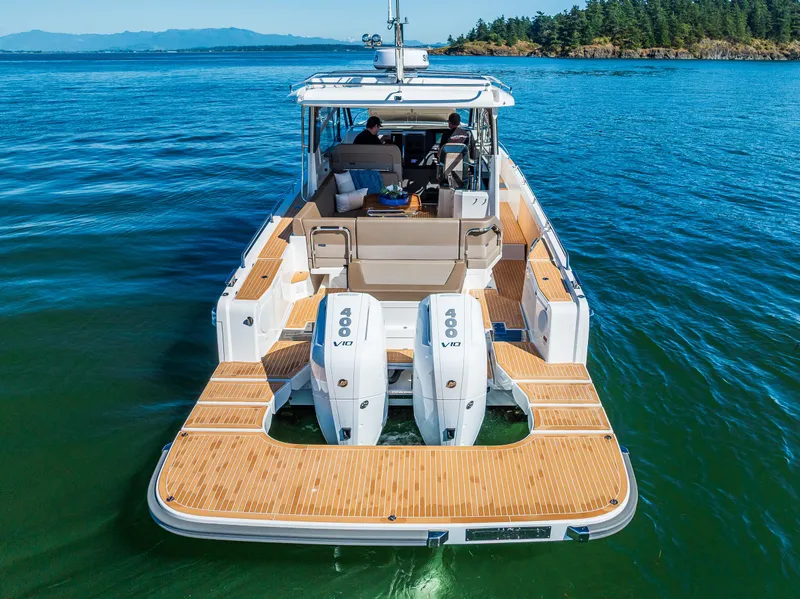 Slide: The Image of Modern Nimbus W11 boat with twin 400 V10 engines on a serene lake, 2025 model. - 9