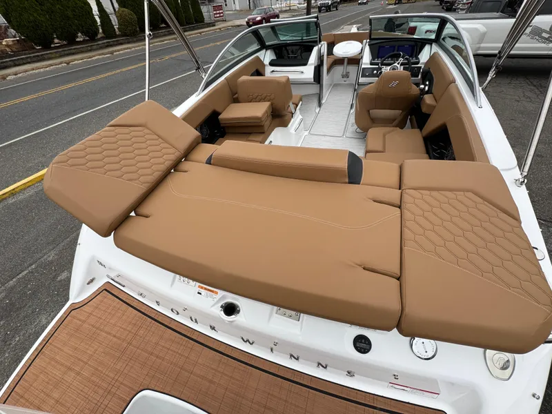 Slide: The Image of 2025 Four Winns H2 OB boat with tan leather seating and modern interior design. - 10