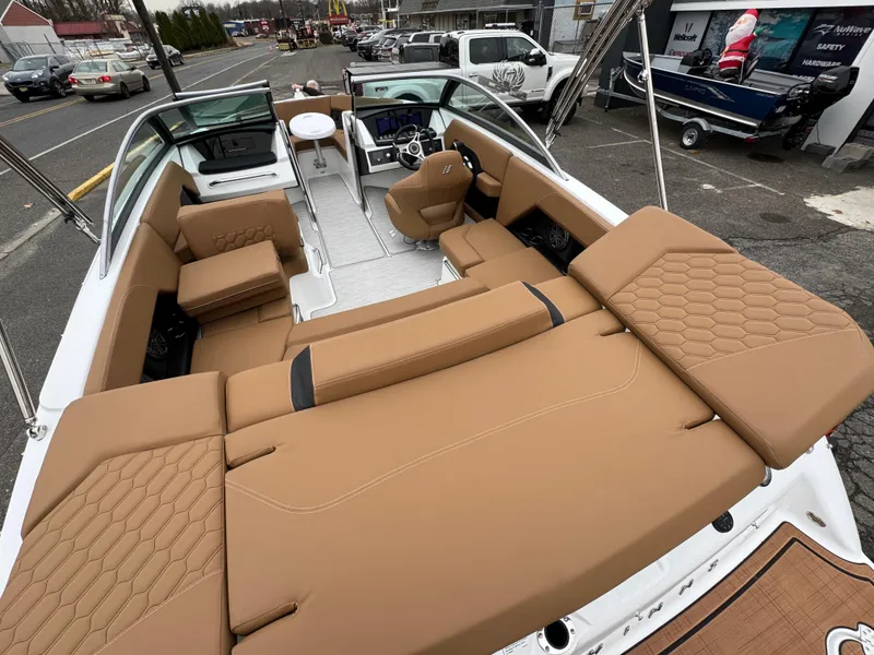 Slide: The Image of 2025 Four Winns H2 OB boat with tan interior, spacious seating, and modern design. - 12