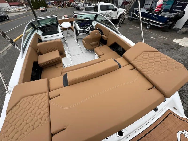 Slide: The Image of 2025 Four Winns H2 OB boat with tan seating and modern interior design. - 13