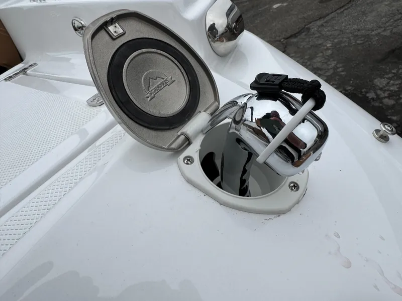 Slide: The Image of 2025 Four Winns H2 OB boat anchor compartment with open lid. - 15