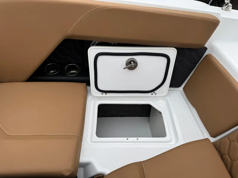 Slide: The Image of 2025 Four Winns H2 OB boat interior with tan seating and storage compartment. - 19