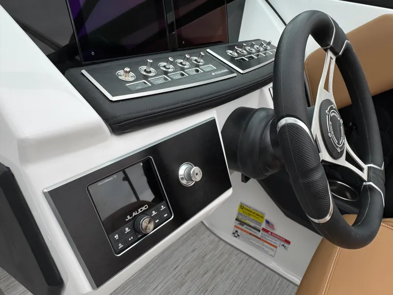 Slide: The Image of 2025 Four Winns H2 OB boat dashboard with steering wheel and control panel. - 23