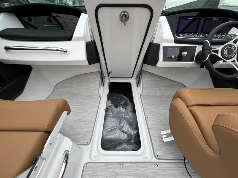 Slide: The Image of 2025 Four Winns H2 OB boat interior with tan seats and modern dashboard. - 26