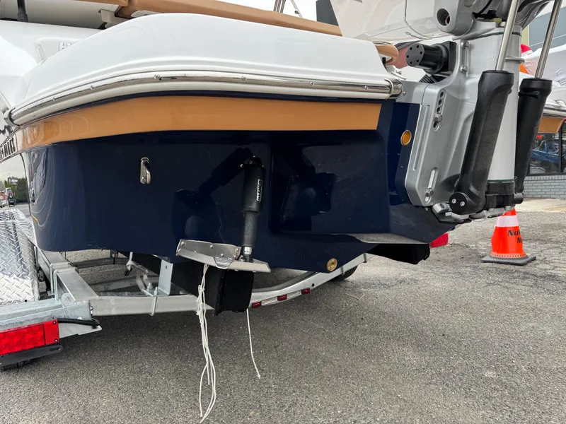 Slide: The Image of 2025 Four Winns H2 OB boat on trailer, rear view with motor and propeller. - 28