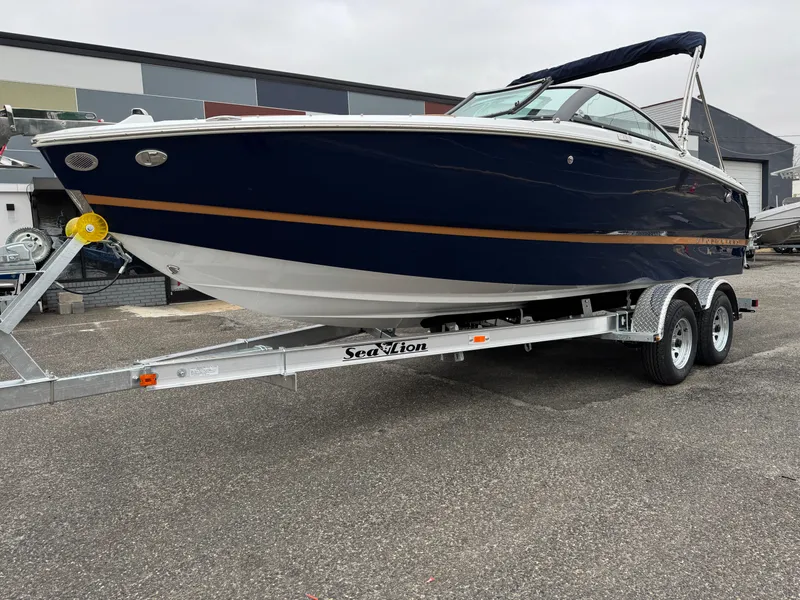 Slide: The Image of 2025 Four Winns H2 OB boat on trailer, sleek design, navy blue hull. - 30