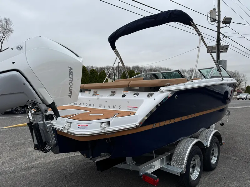 Slide: The Image of 2025 Four Winns H2 OB boat on trailer with Mercury outboard motor. - 31