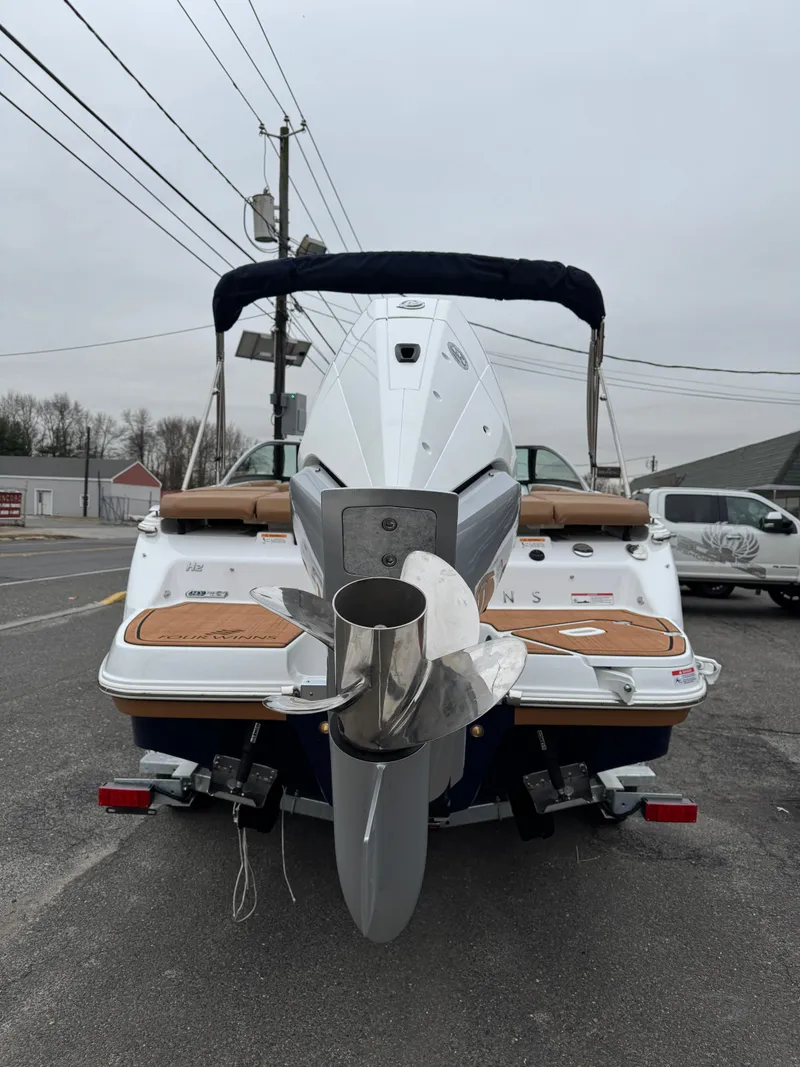 Slide: The Image of 2025 Four Winns H2 OB boat, rear view, parked on street. - 32