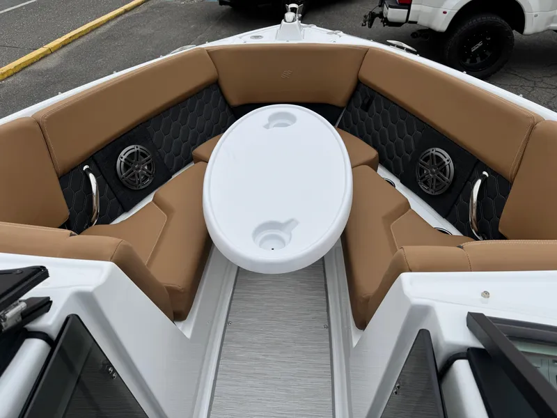 Slide: The Image of 2025 Four Winns H2 OB boat interior with tan seating and white table. - 6