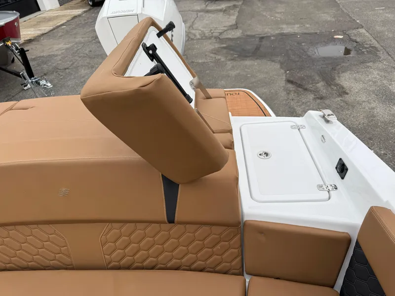 Slide: The Image of 2025 Four Winns H2 OB boat interior with tan seating and storage compartment. - 9