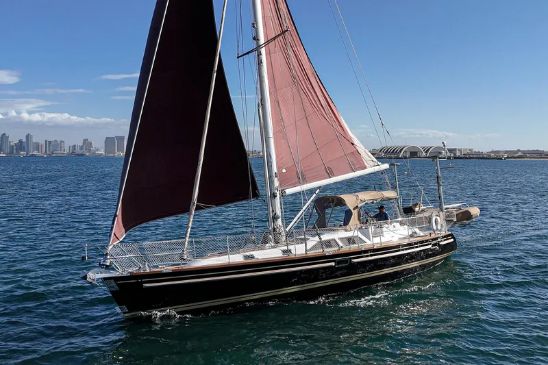 Slide: The Image of Sailing yacht Hylas 46, 2012 model, cruising on open water with city skyline in background. - 0