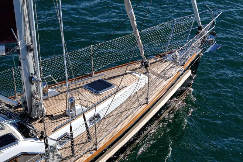 Slide: The Image of Hylas 46 sailboat from 2012 with teak deck on calm water. - 13