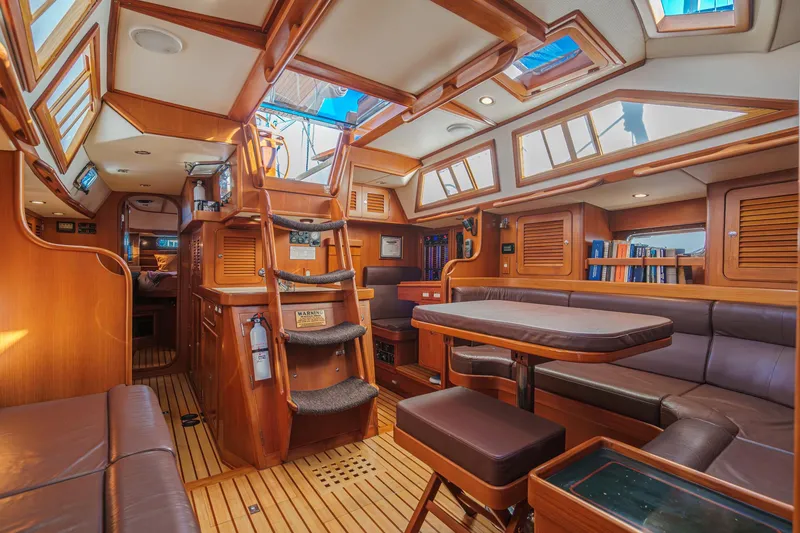 Slide: The Image of Luxurious 2012 Hylas 46 yacht interior with wooden finishes and spacious seating area. - 2
