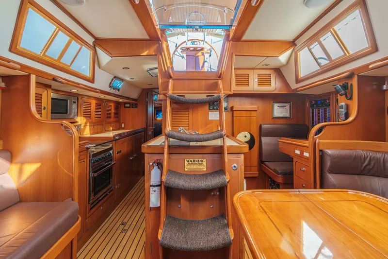 Slide: The Image of Luxurious interior of a 2012 Hylas 46 yacht with wooden finishes and modern amenities. - 22