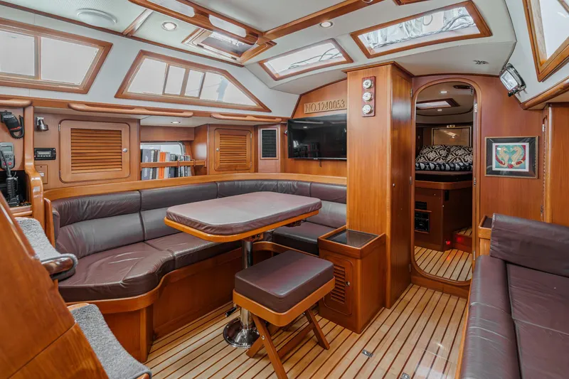 Slide: The Image of Luxurious interior of a 2012 Hylas 46 yacht with wood finishes and leather seating. - 3