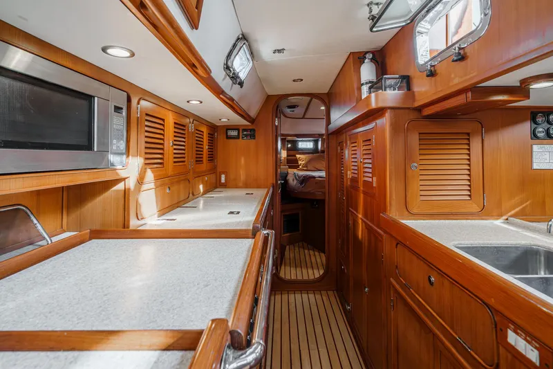 Slide: The Image of Luxurious 2012 Hylas 46 yacht interior with wood cabinetry and modern amenities. - 33