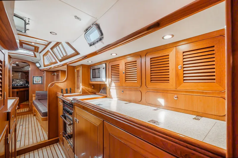 Slide: The Image of Luxurious interior of 2012 Hylas 46 yacht with wooden cabinetry and modern amenities. - 34