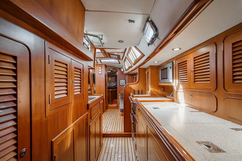 Slide: The Image of Luxurious interior of 2012 Hylas 46 yacht with wooden cabinetry and modern amenities. - 35