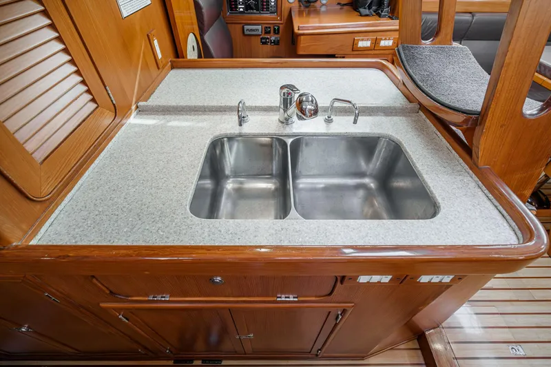 Slide: The Image of Hylas 46 yacht kitchen with double sink, wooden cabinetry, and modern fixtures, 2012 model. - 37