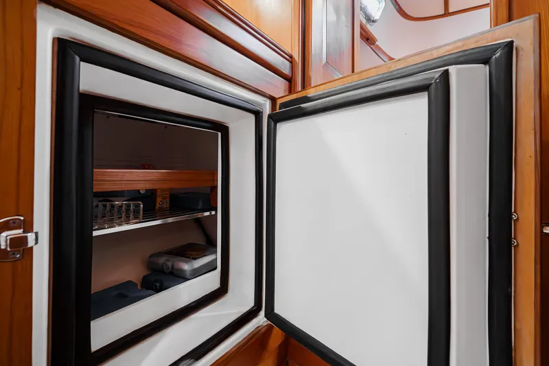 Slide: The Image of Open refrigerator in 2012 Hylas 46 yacht interior, showcasing storage shelves. - 42