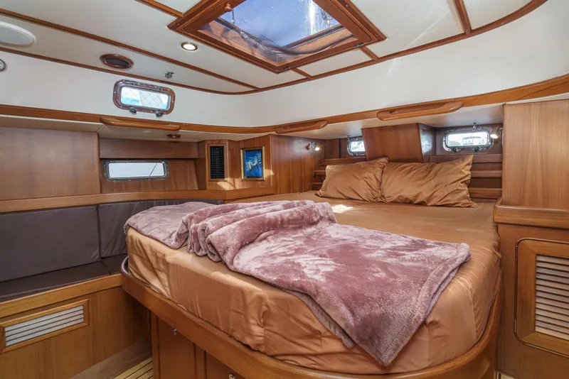 Slide: The Image of Luxurious cabin interior of 2012 Hylas 46 yacht with cozy bedding and wooden accents. - 43