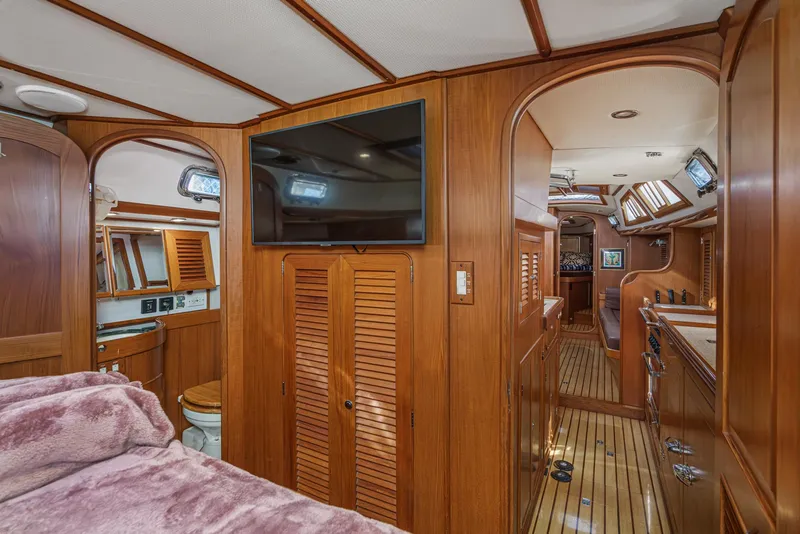 Slide: The Image of Luxurious 2012 Hylas 46 yacht interior with wood paneling and modern amenities. - 44