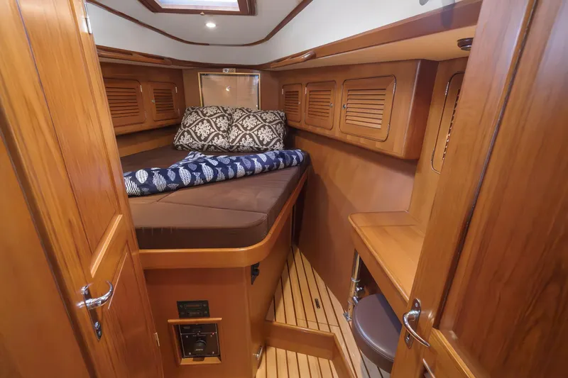 Slide: The Image of Cozy cabin interior of 2012 Hylas 46 yacht with wooden finish and bedding. - 46
