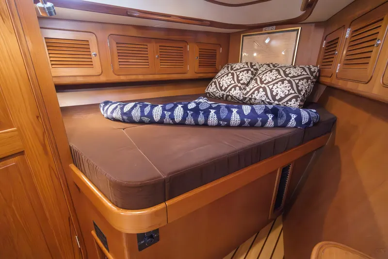 Slide: The Image of Cozy cabin interior of 2012 Hylas 46 yacht with wooden finish and comfortable bedding. - 47