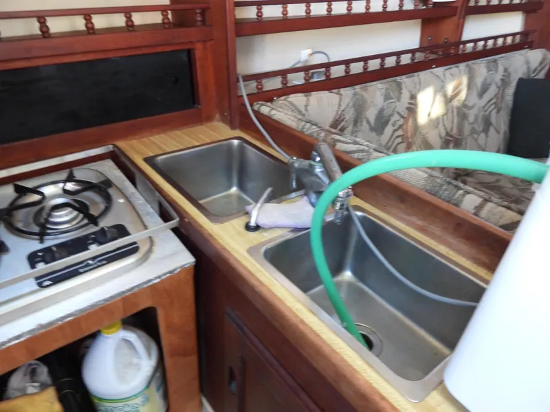 Slide: The Image of 1983 Catalina 30 yacht kitchen area with sink and stove. - 12