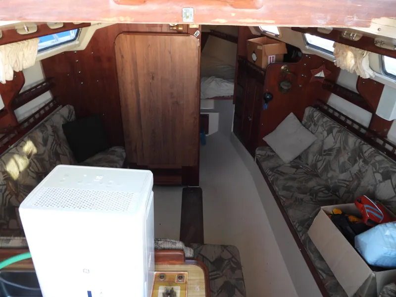 Slide: The Image of Interior of a 1983 Catalina 30 yacht with cozy seating areas. - 5
