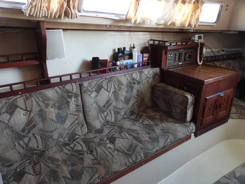 Slide: The Image of Interior of a 1983 Catalina 30 sailboat with cushioned sofa. - 9