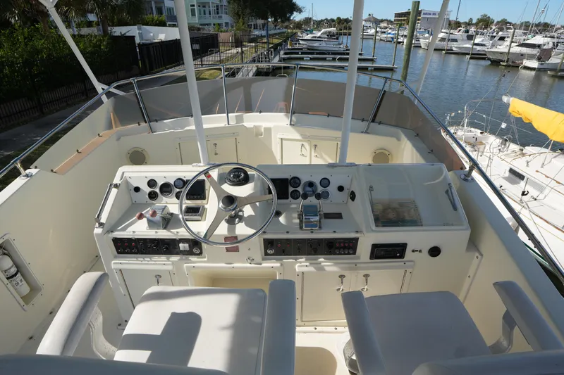 Slide: The Image of Cockpit view of 1987 Hatteras 36 Convertible yacht with steering wheel and control panel. - 10