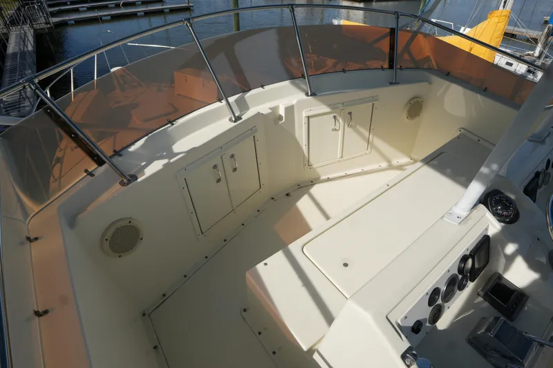 Slide: The Image of 1987 Hatteras 36 Convertible boat cockpit with control panel and storage compartments. - 16